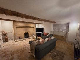 A living room with a sofa and television at 46 North Street, Stoke-Sub-Hamdon, Somerset