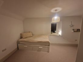 A bedroom with a bed and a lamp at 46 North Street Stoke-Sub-Hamdon Somerset