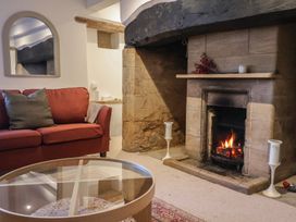 A living room with a fireplace and a sofa at 46 North Street, Stoke-Sub-Hamdon, Somerset