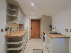 A kitchen with cabinets and a washing machine at 46 North Street Stoke-Sub-Hamdon, Somerset