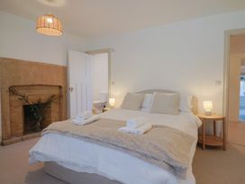 A bedroom with a bed and fireplace at 46 North Street, Stoke-Sub-Hamdon, Somerset