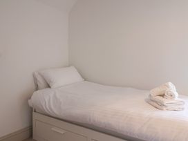 A bedroom with a bed and towels folded on top at 46 North Street Stoke-Sub-Hamdon, Somerset