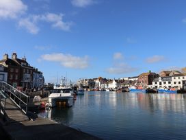 A harbor with boats and buildings at 46 North Street Stoke-Sub-Hamdon Somerset
