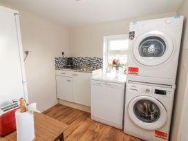 A laundry room with a washing machine and dryer at Kate's Cottage
