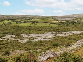 A landscape featuring hills and fields with rock formations in the distance at Kate's Cottage