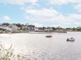 A view of boats on water with houses in the background at Kate's Cottage in 