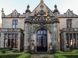 An entrance with stone facade and decorative features at Summerlands Hall Apartment