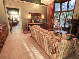 A living room with a sofa and armchair at Summerlands Hall Apartment