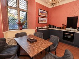 A kitchen with a table and chairs at Summerlands Hall Apartment