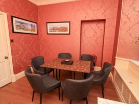 A dining room with a table and chairs at Summerlands Hall Apartment