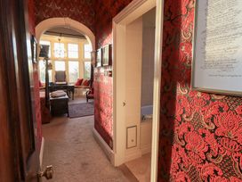 A hallway with a door leading to a bathroom at Summerlands Hall Apartment