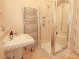 A bathroom with a sink and shower at Summerlands Hall Apartment