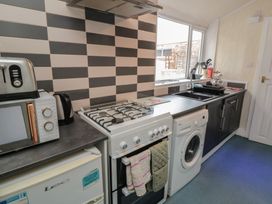 A kitchen with appliances and cabinets at 170 Victoria Road