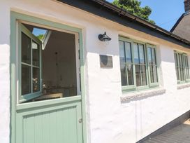 The entrance of Lavender Cottage with a green door and windows