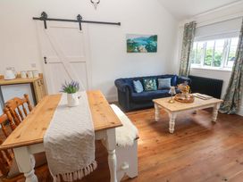 A living room with a table and chairs at Lavender Cottage 