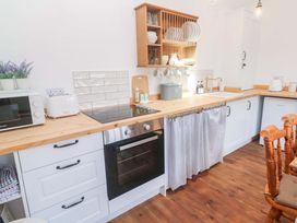 A kitchen with appliances and wooden countertops at Lavender Cottage