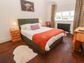 A bedroom with a bed and nightstands at Lavender Cottage