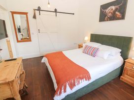 A bedroom with a bed and bedside tables at Lavender Cottage