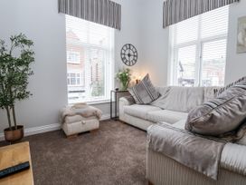 A living room with a sofa and plant at No 2 Emporium Apartments in Prestatyn