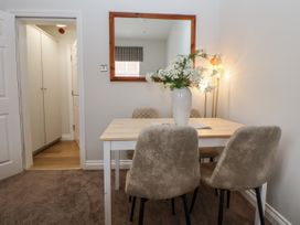 A dining room with a table and chairs at No 2 Emporium Apartments Prestatyn