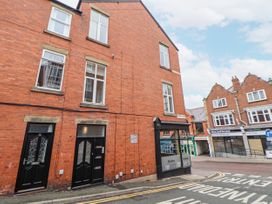 A brick building with multiple windows and entrance doors at No 2 Emporium Apartments Prestatyn