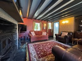 A living room with a sofa and armchair at St. James Cottage Liskeard