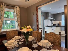 A dining room with a table set for a meal at St. James Cottage in Liskeard