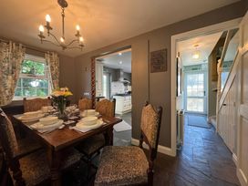 A dining room with a table and chairs at St. James Cottage in Liskeard