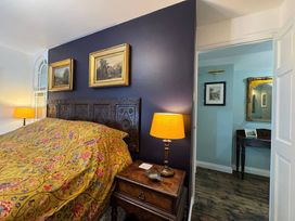 A bedroom with a bed and bedside lamp at St. James Cottage Liskeard