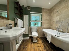 A bathroom with a sink, toilet, and bathtub at St. James Cottage in Liskeard