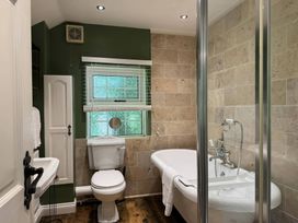 A bathroom with a bathtub and toilet at St. James Cottage in Liskeard