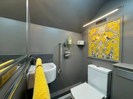 A bathroom with a sink and a white toilet at St. James Cottage in Liskeard