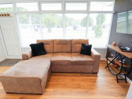 A living room with a sofa and a television at 66 Cherry Park Skegness