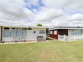 A house with a front entrance and outdoor seating at 66 Cherry Park Skegness