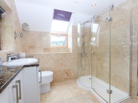 A bathroom with a shower and sink at Ty Newydd Llanrhychwyn near Llanrwst
