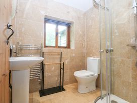 A bathroom with a sink, toilet, and shower at Ty Newydd Llanrhychwyn near Llanrwst