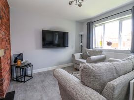 A living room with a sofa and television at Dan’s Holiday Cottage in Driffield