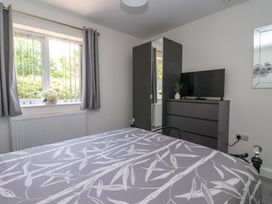 A bedroom with a bed, TV, and wardrobe at Dan’s Holiday Cottage in Driffield