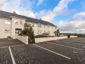 A building with windows and parking spaces at King Arthur Suite in Trearddur Bay
