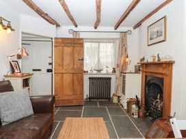 A living room with a sofa and fireplace at Carpenters Cottage Okehampton