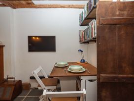 A dining room with a table and chairs at Carpenters Cottage Okehampton