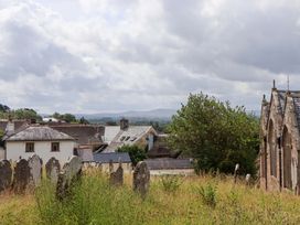 A view of rooftops and gravestones at Carpenters Cottage in Okehampton