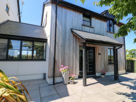 A wooden house with a front door and window at Just A Cottage in St Florence