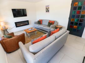 A living room with a sofa and armchair at Just A Cottage in St Florence