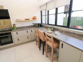 A kitchen with stools and countertop at Just A Cottage in St Florence