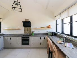 A kitchen with appliances and seating at Just A Cottage in St Florence