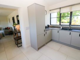 A kitchen with a fridge and sink at Just A Cottage St Florence