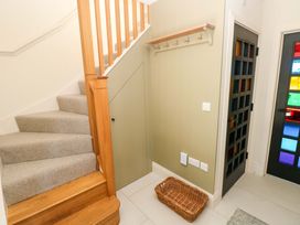 A hallway with stairs and a basket at Just A Cottage St Florence