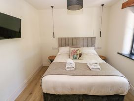 A bedroom with a bed and television at Just A Cottage in St Florence