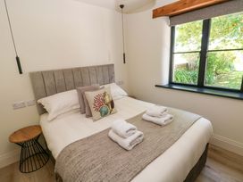 A bedroom with a bed and towels arranged at Just A Cottage in St Florence